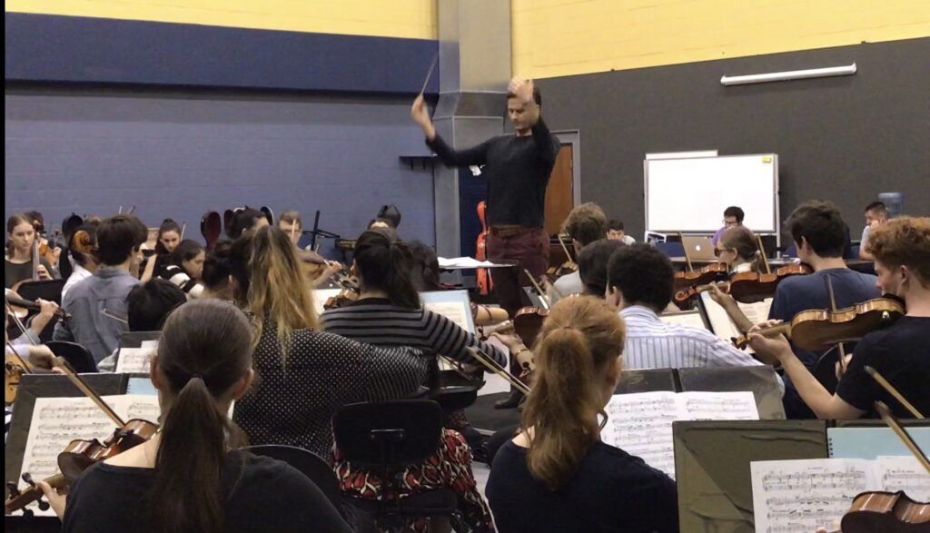 Conductor and orchestra rehearsal